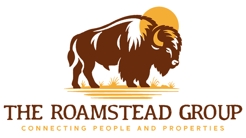 A stylized logo featuring a brown bison standing on a grassy plain with a golden sun behind it, accompanied by the text “The Roamstead Group Connecting People and Properties"